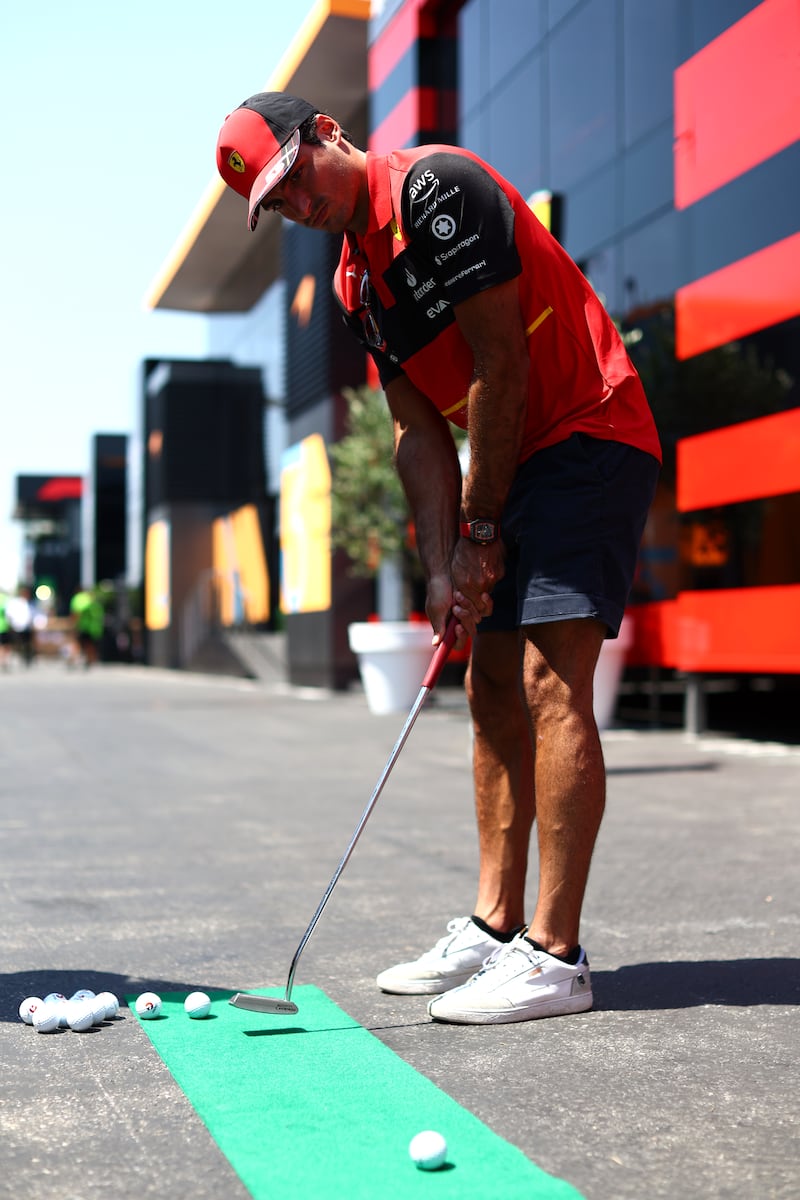 Down time: the Ferrari driver Carlos Sainz plays golf in the paddock before the Grand Prix of France in July. Photograph: Clive Rose/Getty