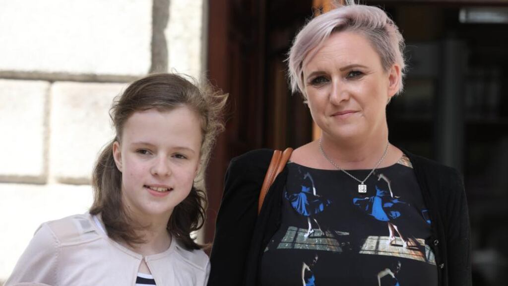 Katie McGuane (13) with her mother Niamh leaving the Four Courts. Photograph: Collins Courts