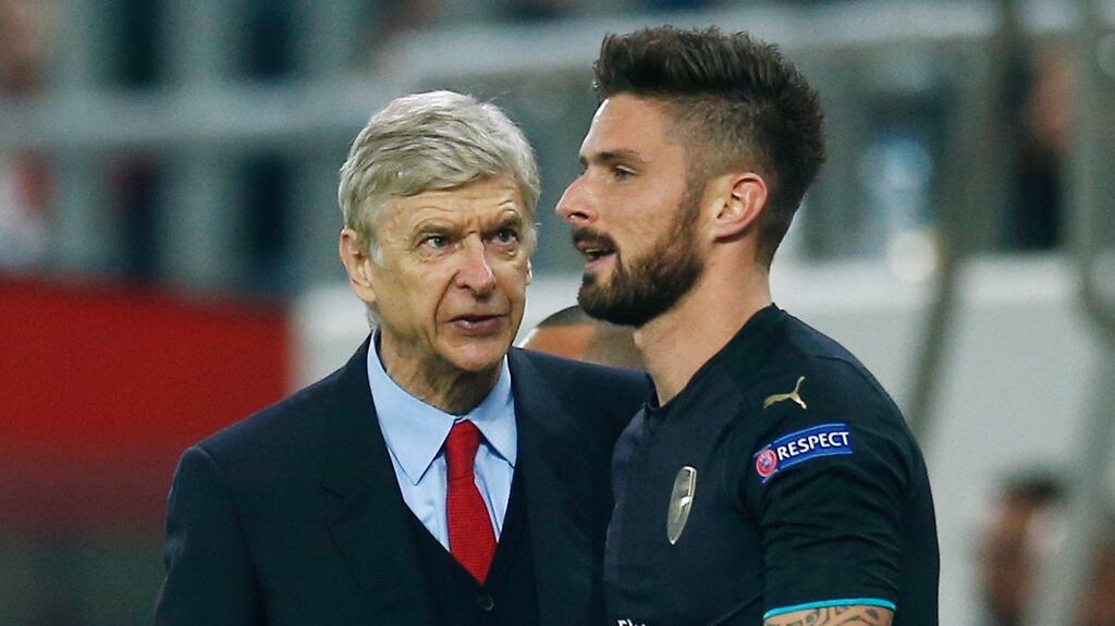 Olivier Giroud celebrates with Arsenal manager Arsene Wenger after scoring the third goal and completing his hat trick against Olympiakos on Wednesday in Athens. Photograph: Andrew Couldridge/Reuters