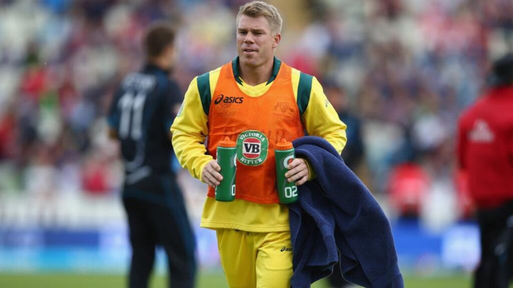 David Warner takes on drinks during the ICC Champions Trophy Group A match between Australia and New Zealand at Edgbaston. Photograph: Michael Steele/Getty Images