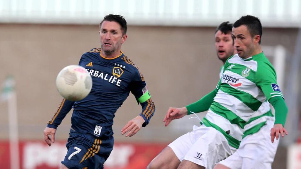 Robbie Keane of LA Galaxy is challenged by Keith Fahey of Shamrock Rovers during the match in Tallaght. Photograph: Donall Farmer/Inpho