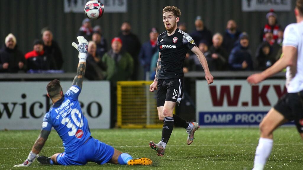 Derry’s Jamie McGonigle chips over Sligo Rovers’ goalkeeper Richard Brush. Photo: Lorcan Doherty/Inpho