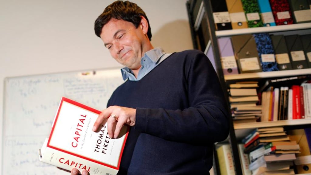 French economist and academic Thomas Piketty, poses in his book-lined office at the French School for Advanced Studies in the Social Sciences in Paris. Photograph: Charles Platiau/Reuters
