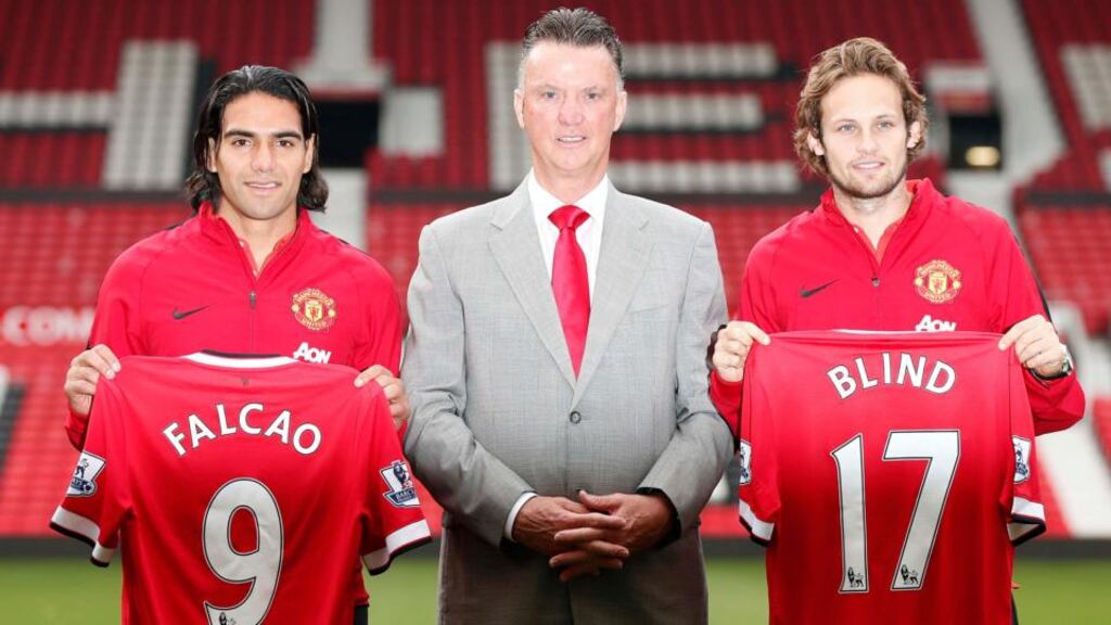 New Manchester United signings Radamel Falcao (left) and Daley Blind (right) pose with manager Louis Van Gaal at Old Trafford. Photograph: Phil Noble / Reuters