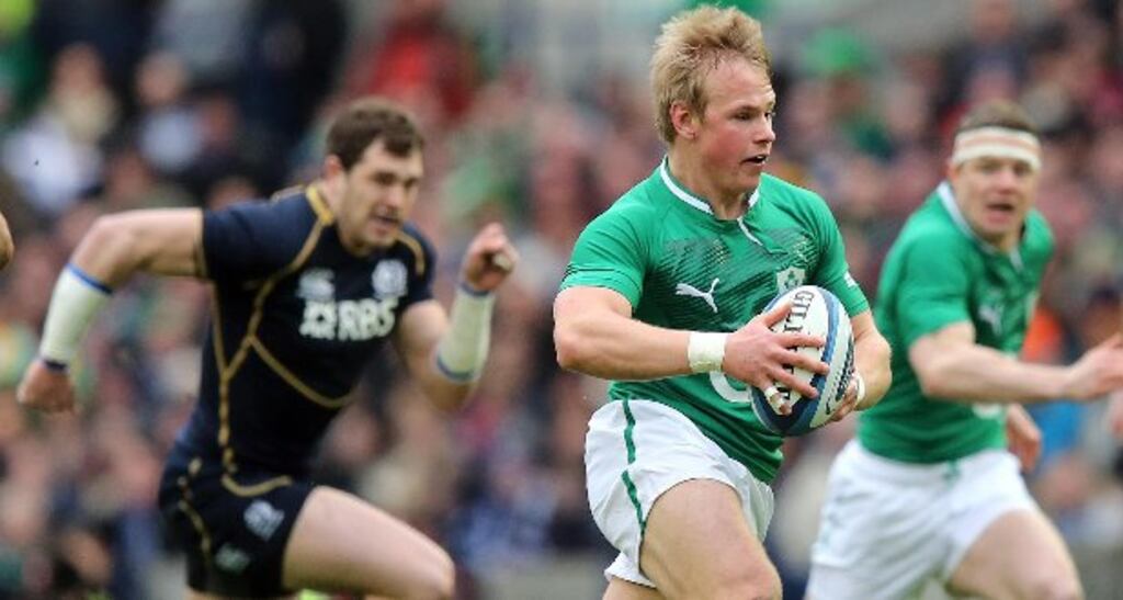 Luke Marhsall makes a break against Scotland at Murrayfield.