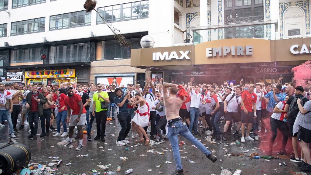 England supporters throw a tree as they gather in Leicester Square before the Euro 2020 final against Italy. Photo: Joshua Bratt/EPA