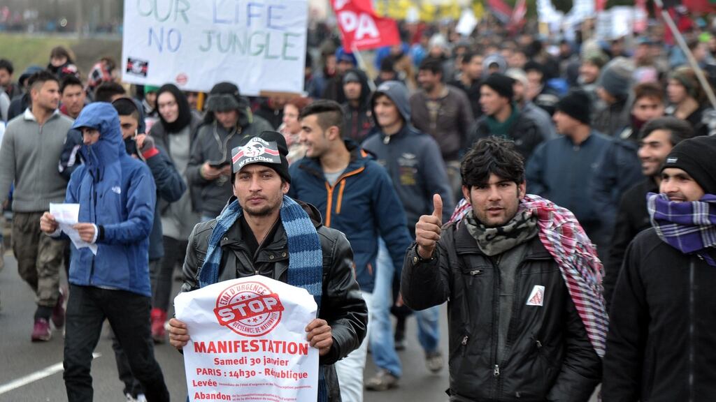 Migrants march on in the French port city of Calais, northern France, during a demonstration to support migrants and refugees who live in the ‘jungle’. Photograph: Francois Lo Presti/AFP/Getty Images