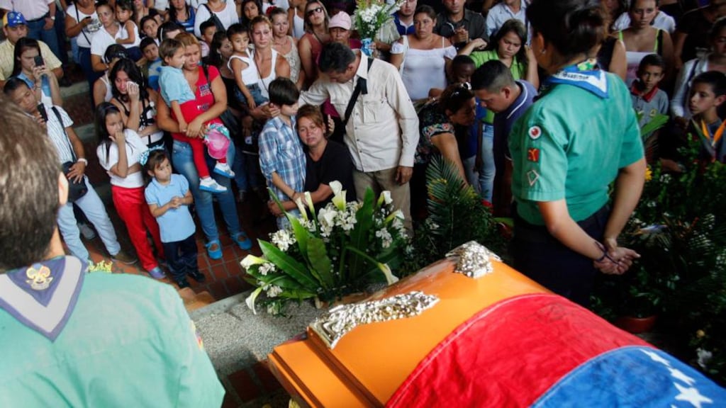 People stand in front of the coffin of Kluiver Roa during his funeral. The 14-year-old was fatally shot at an anti-government protest in the western city of San Cristobal in Venezuela on Tuesday. Photograph: Carlos Eduardo Ramirez/Reuters