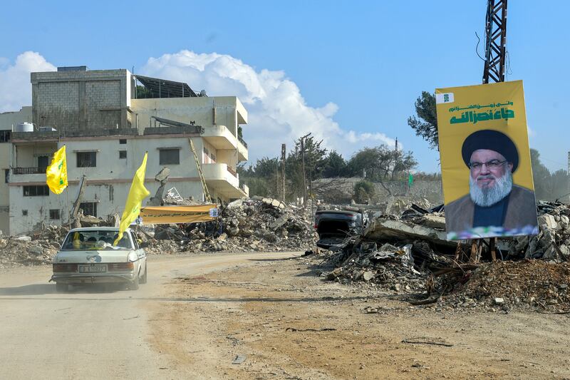 Residents of the southern Lebanese village of Khiam drive past a portrait of slain Hizbullah leader Hassan Nasrallah as they return to their village. Photograph: Rabih DAHER/AFP via Getty