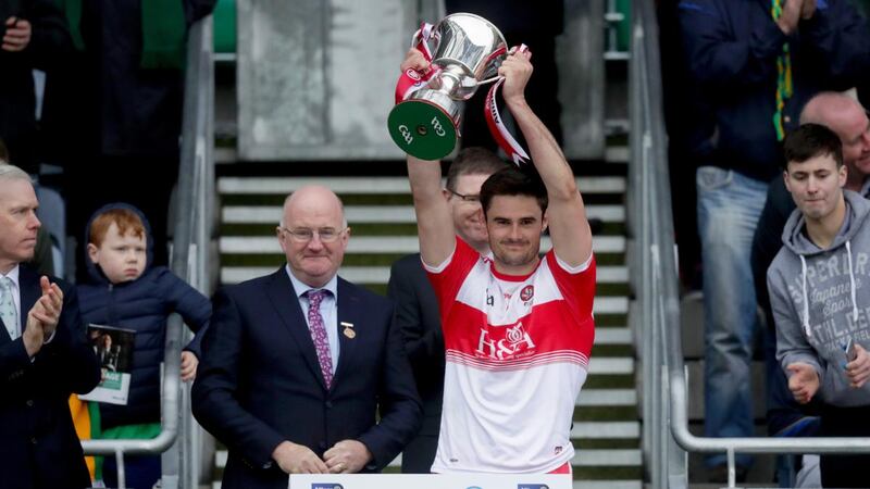 Derry captain Christopher McKaigue lifts the trophy after the victory over Leitrim in the Allianz Football League Division 4 Final at Croke Park. Photograph: Oisín Keniry/Inpho
