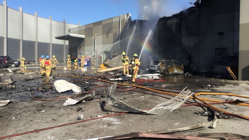 Metropolitan Fire Brigade putting out a blaze from the light aircraft which exploded as it smashed into a shopping centre near Melbourne. Photograph: Metropolitan Fire Brigade/AFP/Getty Images