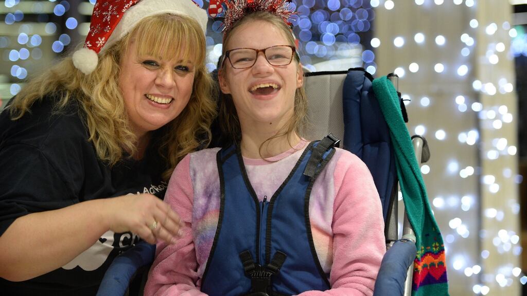 Trina Rooney from Oldtown welcomes Maryna Malinovskaya as a group of 30 children and young adults with special needs from the Chernobyl-affected region of Belarus arrive at Dublin Airport for a Christmas holiday with their host families. Photograph: Dara Mac Dónaill/The Irish Times