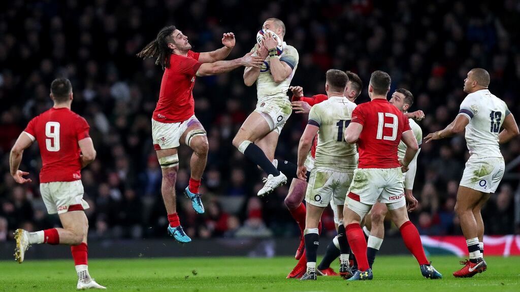 Wales’ Josh Navidi competes for a high ball with Mike Brown of England during their Six Nations clash at Twickenham. Photo: James Crombie/Inpho