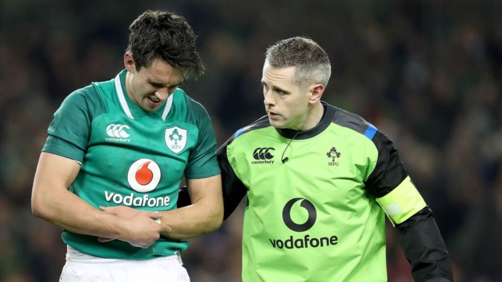Ireland’s Joey Carbery leaves the field in pain with Dr Ciarán Cosgrove after fracturing his left forearm. Photograph: Dan Sheridan/Inpho
