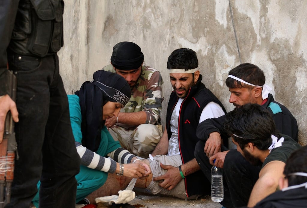 A nurse helps a wounded man after he was shot by a sniper loyal to Syria’s President Bashar al-Assad in Aleppo’s Salaheddine neighbourhood. Photograph: Ammar Abdullah/Reuters