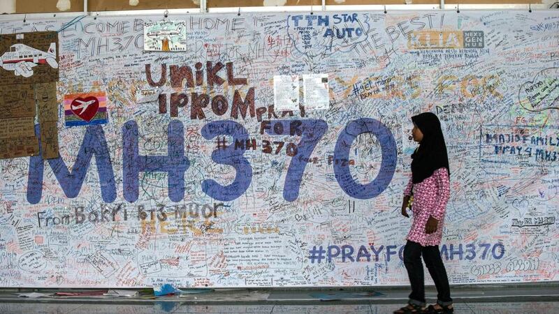 A girk walks in front of the wall of hope for missing Malaysia Airline flight MH370 at Kuala Lumpur International Airport (KLIA). Photograph: Ahmed Yusni/EPA