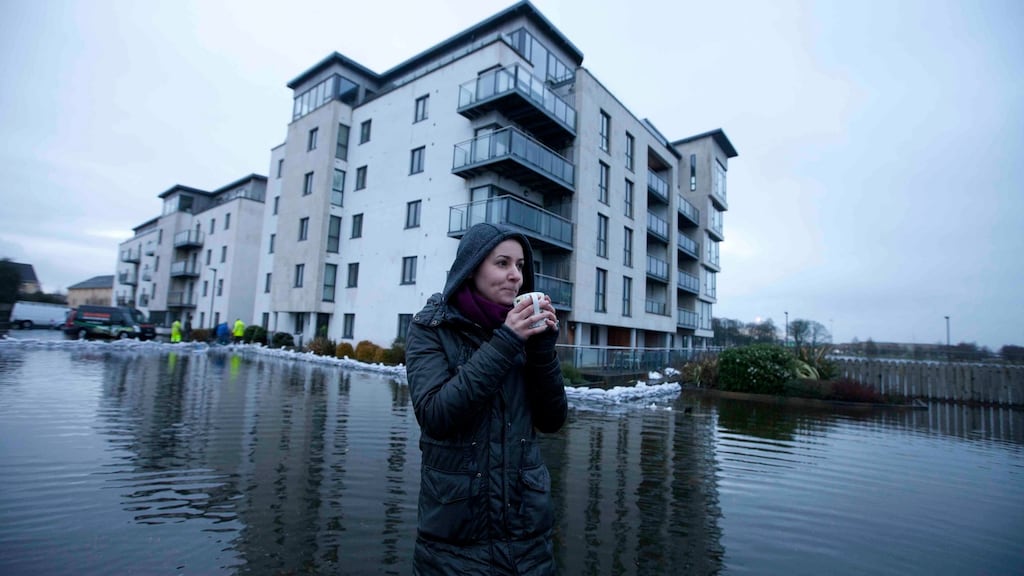 Emily Topka from Poland outside the Bastion Apartments in Athone, Co Westmeath, where she owns a ground floor appartment.  So far water has not entered the building. Photograph: RollingNews.ie