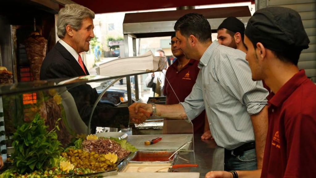 US secretary of state John Kerry greets workers as he visits a restaurant in the West Bank city of Ramallah yesterday. Photograph: Jim Young/Reuters