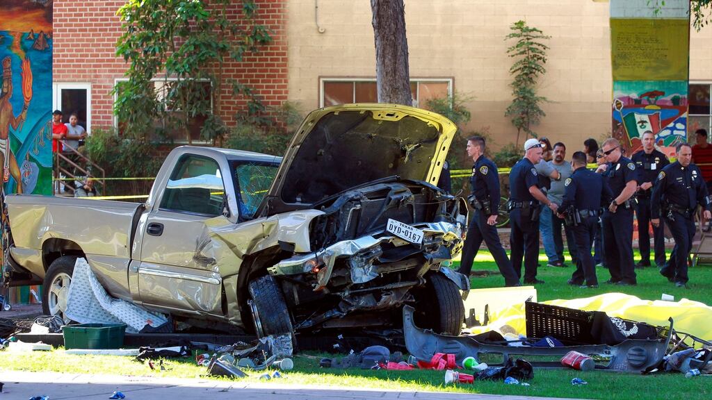 Police stand near the pickup truck that landed at Chicano Park after it flew off a ramp to the San Diego Coronado Bridge in San Diego on Saturday. Photograph: Hayne Palmour IV/The San Diego Union-Tribune via AP