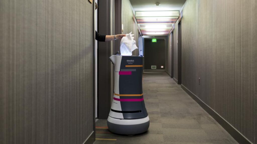 Room service: the A.L.O. by Savioke delivers fresh towels to a hotel guests’ room. Photograph:  Jason Henry/The New York Times