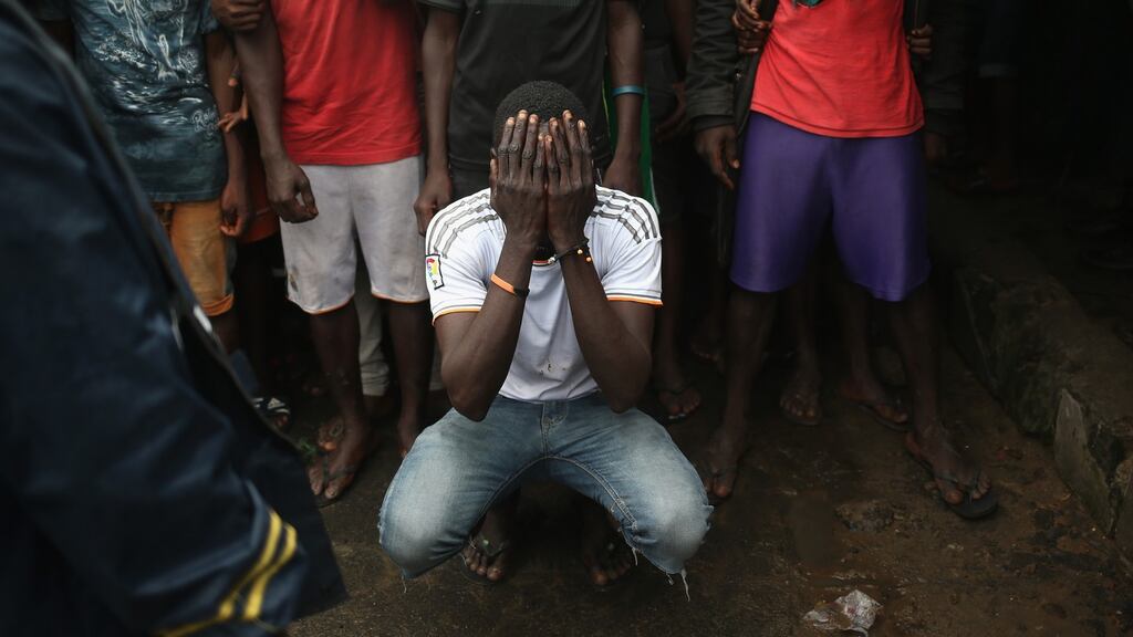 Residents of the West Point slum wait for food aid during the second day of the government’s Ebola quarantine on their neighbourhood in Monrovia, Liberia, on Thursday. Photograph: John Moore/Getty Images)