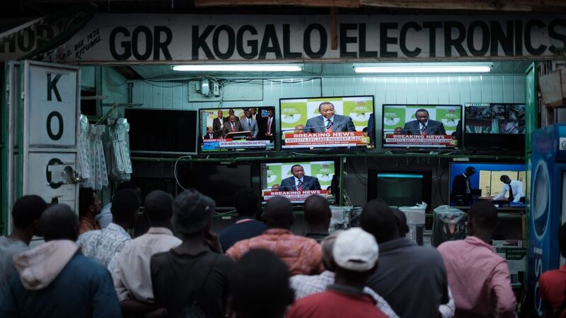 Kenyans watch as Uhuru Kenyatta is declared the winner of the rerun presidential election, at a local electrical shop in Kisumu. Photograph: Yasuyoshi Chiba/AFP/Getty Images