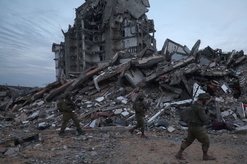 Israeli soldiers walking past the rubble of destroyed buildings in the Palestinian town of Beit Lahia on December 8th. Photograph: Atef Safadi/EPA-EFE