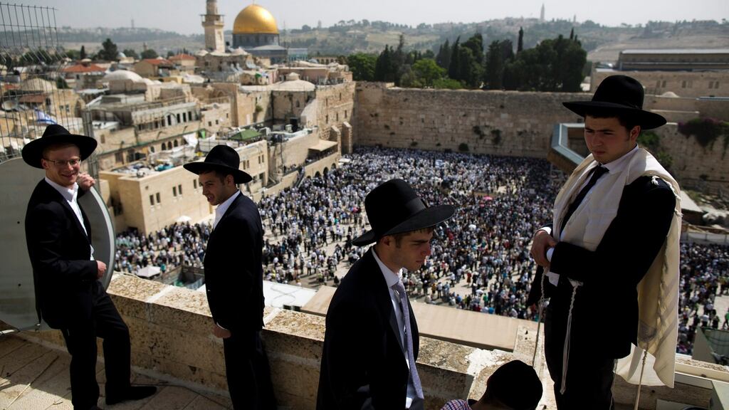 Ultra-Orthodox Jews during a  priestly blessing at the high holiday of Passover in April 2016 in front of the Western Wall in Jerusalem, Israel. The Temple Mount or al-Aqsa Mosque is visible  to the centre-left. File photograph: Abir Sultan/EPA