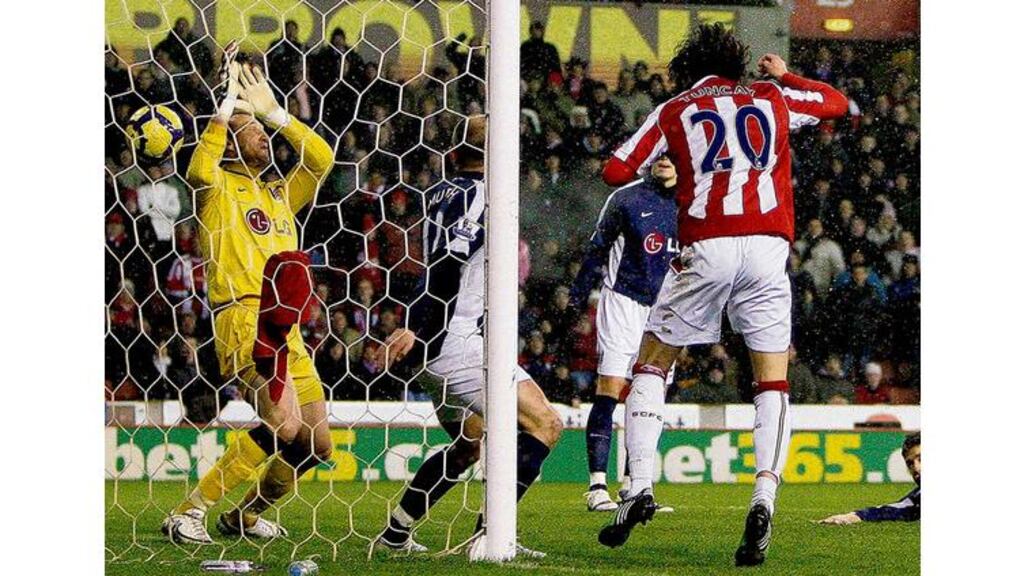 Stoke City's Tuncay (number 20) heads past Fulham goalkeeper Mark Schwarzer during their English Premier League match at the Britannia Stadium, Stoke-on-Trent, last night. Stoke fought off Fulham's late comeback to hold out for a 3-2 victory and move up to tenth place in the table . - (Photograph: Darren Staples/Reuters)
