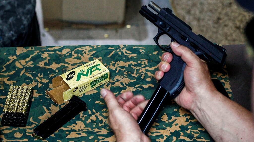 A man reloads a gun at a shooting club in Sao Paulo. Brazil suffered a record 64,000 murders in 2017, the most in the world. Nearly 45,000 of those homicides involved firearms. Photograph: Miguel Schincariol/AFP/Getty Images