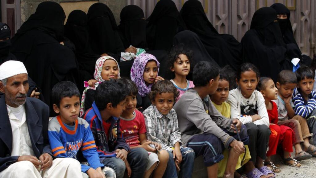 Yemenis wait to receive food aid from a local relief group providing aid to people affected by ongoing conflict, in Sana’a, Yemen. Photograph: Yahya Arhab/EPA