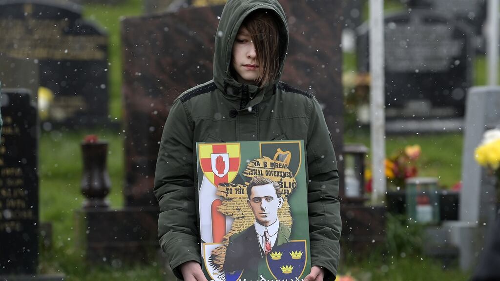 A young dissident republican supporter in Derry City cemetery during the 1916 wreath laying event as snow falls. Photograph: Getty