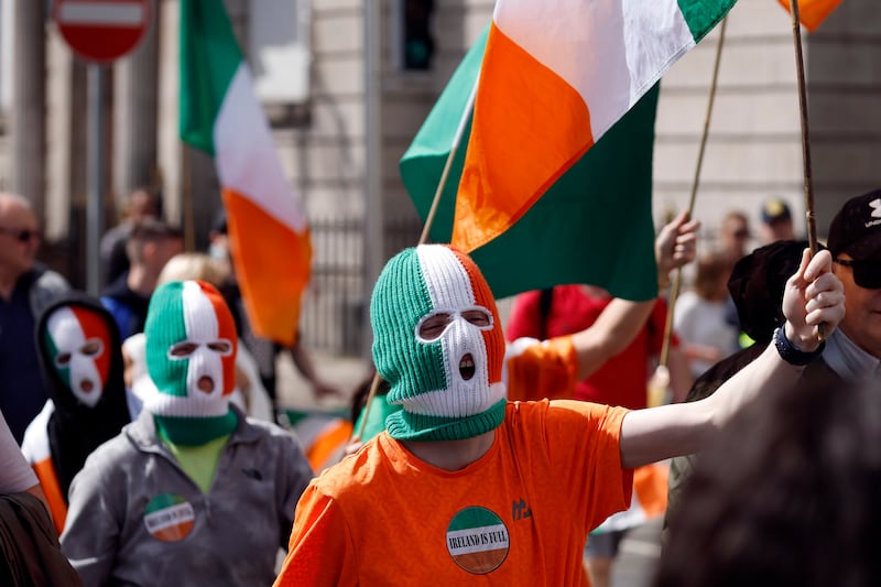 Protesters in tricolour balaclavas join the march. Photograph: Conor O Mearain/PA Wire