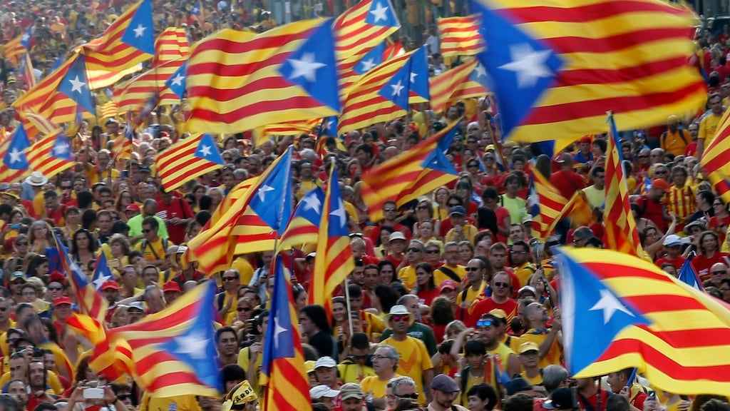 People hold Catalan separatist flags during the Diada celebration in Barcelona: the current drive for independence began in 2012, when Madrid refused to discuss increased economic autonomy for the northeastern region. Photograph: Albert Gea/Reuters