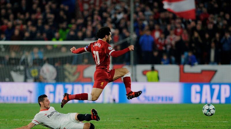 Liverpool’s Egyptian midfielder Mohamed Salah jumps for the ball against Sevilla. Photograph: Cristina Quicler/AFP/Getty Images