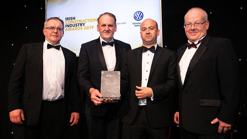Brendan O'Riordan, CEO, Zutec presents the Education Project of the Year award to the Stewart Construction team.
