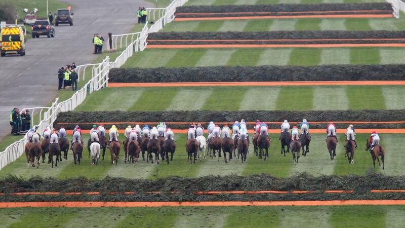 Runners and riders clear the first in the Grand National at Aintree. Photo: Pete Byrne/PA Wire