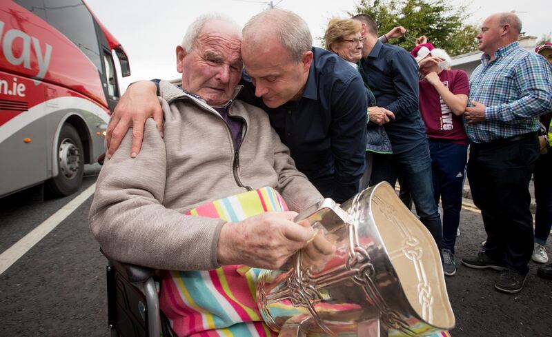Galway manager Micheal Donoghue shows the Liam McCarthy to his father Miko Donoghue in Ballinasloe in 2017. Photograph: Morgan Treacy / INPHO