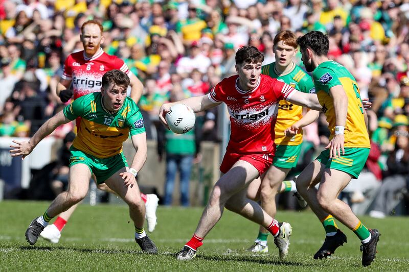 Derry's Pádraig McGrogan  comes under pressure from Donegal's Shane O'Donnell, Ciarán Moore and Ryan McHugh during the Ulster Championship match in Ballybofey. Photograph: Lorcan Doherty/Inpho