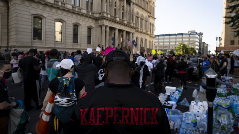 A protestor wears a Colin Kaepernick jersey as he and others gather outside city hall in Louisville, Kentucky on Friday. Photo: Brett Carlsen/Getty Images