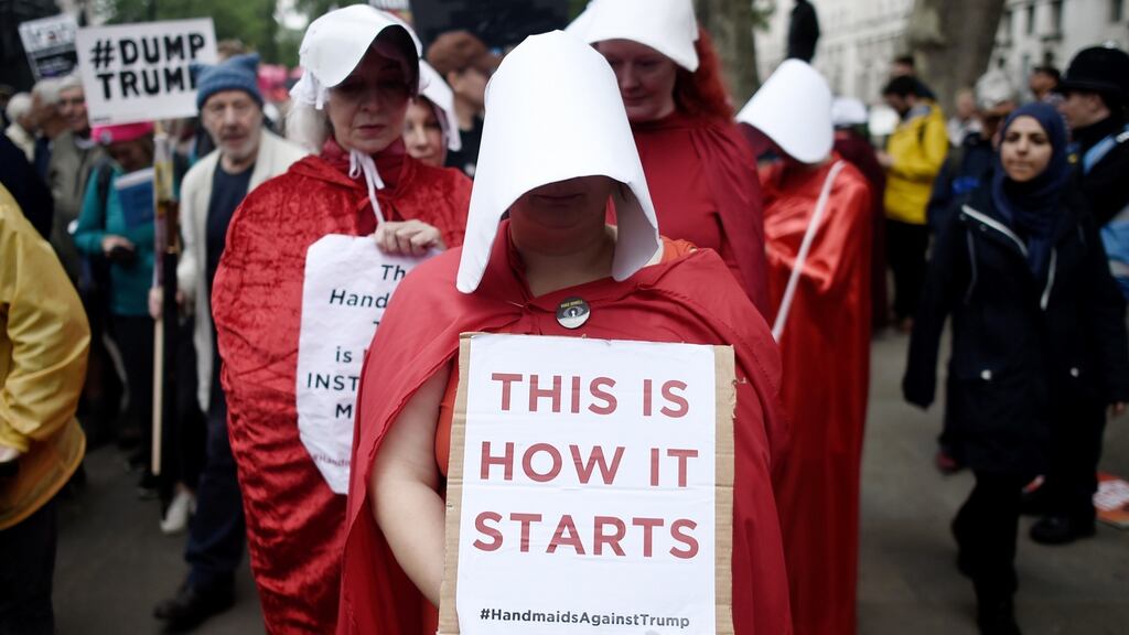 Protesters dressed as characters from A Handmaid’s Tail during a demonstration outside the Houses of Parliament, London, on the second day of Donald Trump’s visit. Photograph: Peter Summers/Getty Images