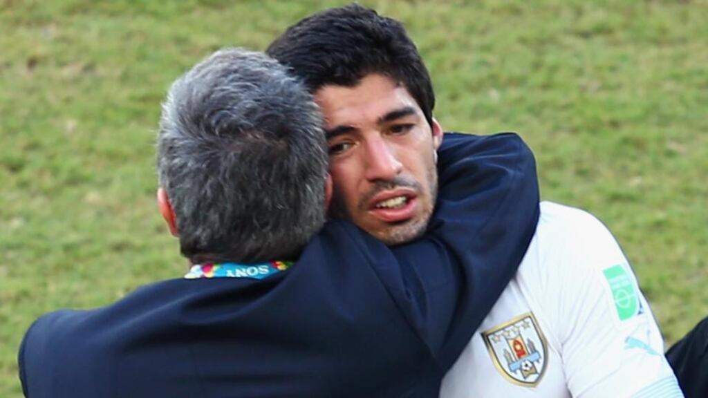 Head coach Oscar Tabarez of Uruguay hugs Luis Suarez after their 1-0 victory over Italy at Estadio das Dunas in Natal, Brazil. Photograph: Julian Finney/Getty Images