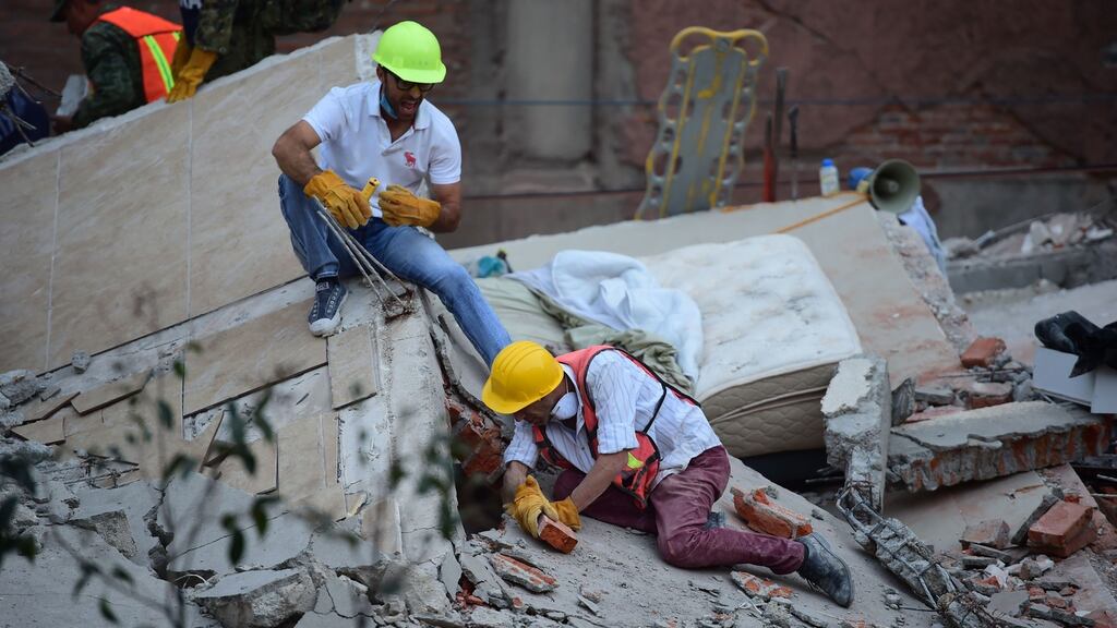 Rescuers search for survivors after the Mexican quake. Photograph: AFP/Ronaldo Schemidt