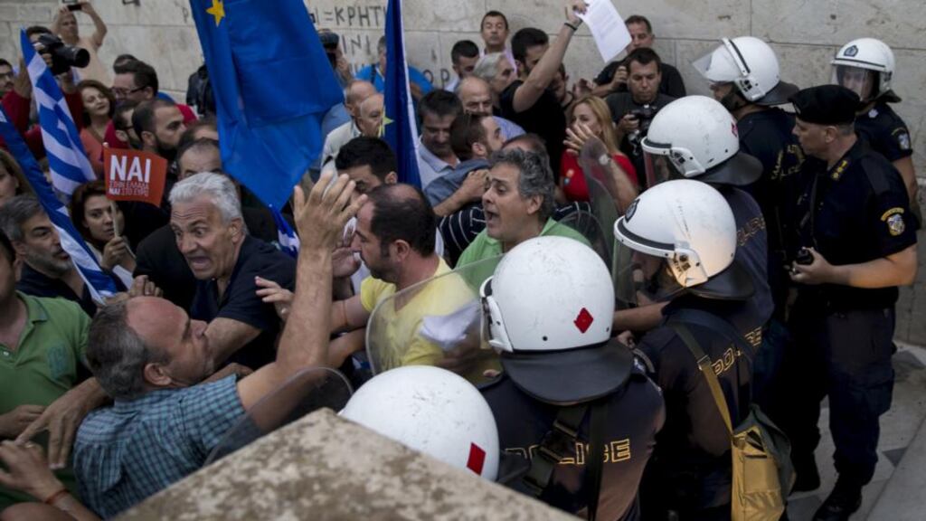 Pro-euro protesters tussle with riot police at a rally in front of the Greek parliament building in Athens on Tuesday night. Photograph: Marko Djurica/Reuters