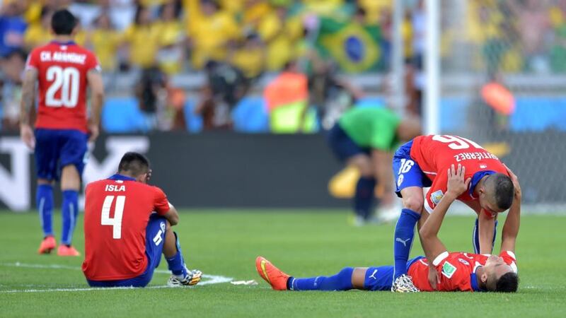 Chile players after being defeated by Brazil in a penalty shootout during the 2014 Fifa World Cup second round match at Mineirao Stadium. Photograph: Buda Mendes/Getty Images