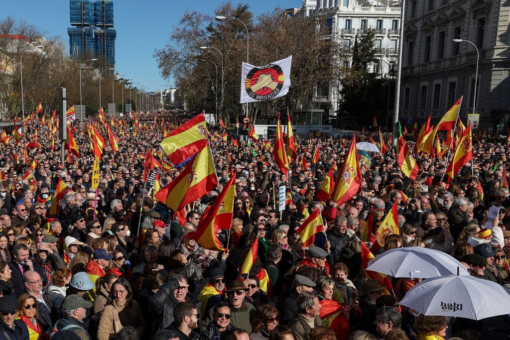 Protesters wave Spanish national flags as they gather in Madrid's Plaza de Cibeles during an anti-government demonstration called by right-wing groups. Photograph: Pierre-Philippe Marcou/AFP via Getty Images