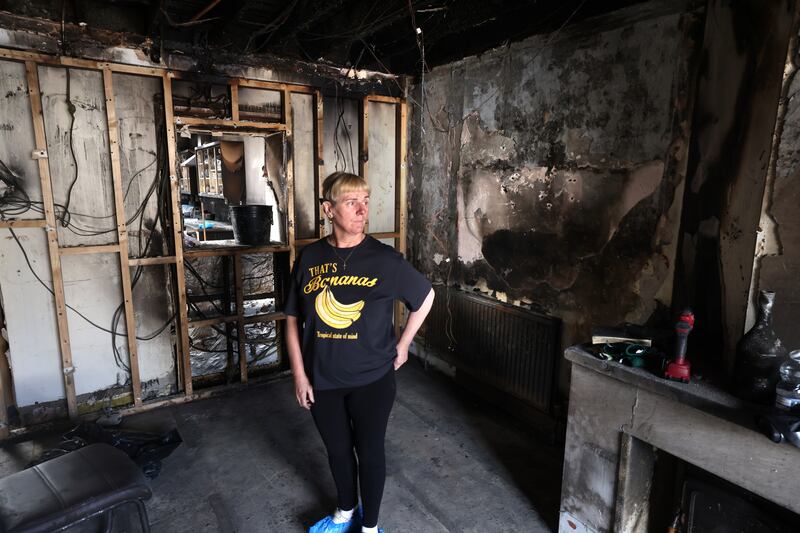 Breda Curran takes in the damage to her home after the arson attack, in Ballyfermot, Dublin. 
Photograph: Dara Mac Dónaill/The Irish Times