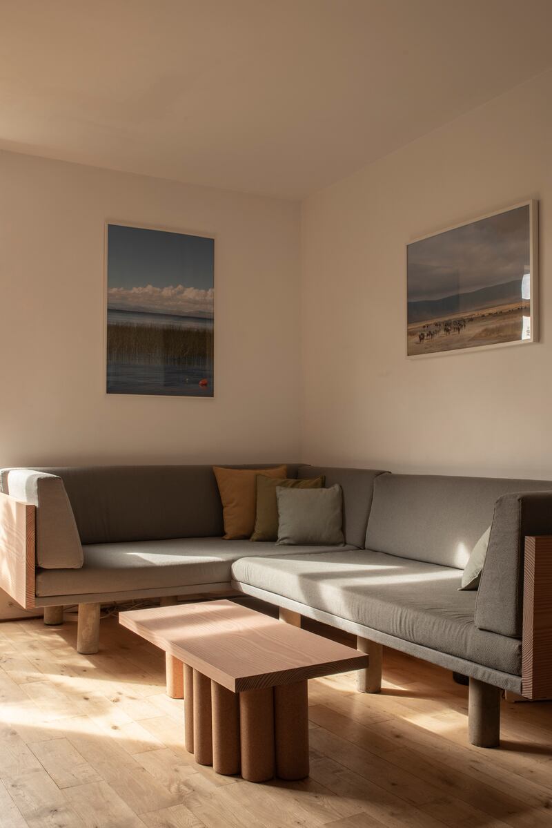 Couch in the living room with concrete legs cast in pipes