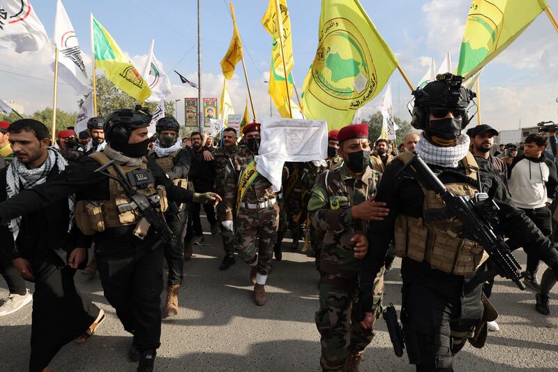 Members of Hashed al-shaabi forces carry the coffin of a comrade, who died in American air strikes targeting Iran-backed groups, during his funeral at the Hashed al-shaabi forces' headquarters in Baghdad. Photograph: by Ahmad Al-Rubaye/AFP via Getty Images