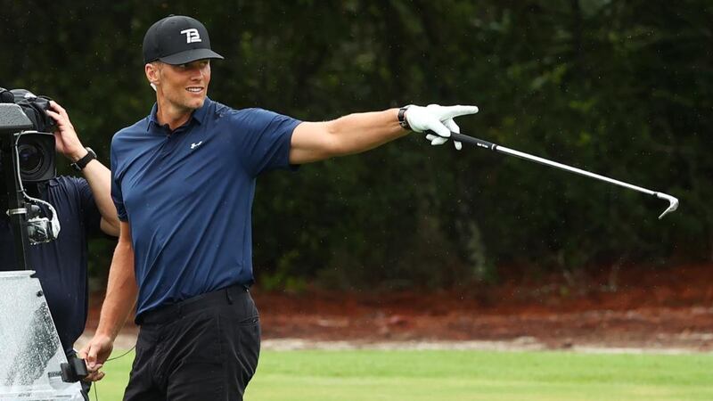 Tom Brady celebrates after holing out for birdie on the seventh hole. Photograph: Mike Ehrmann/Getty